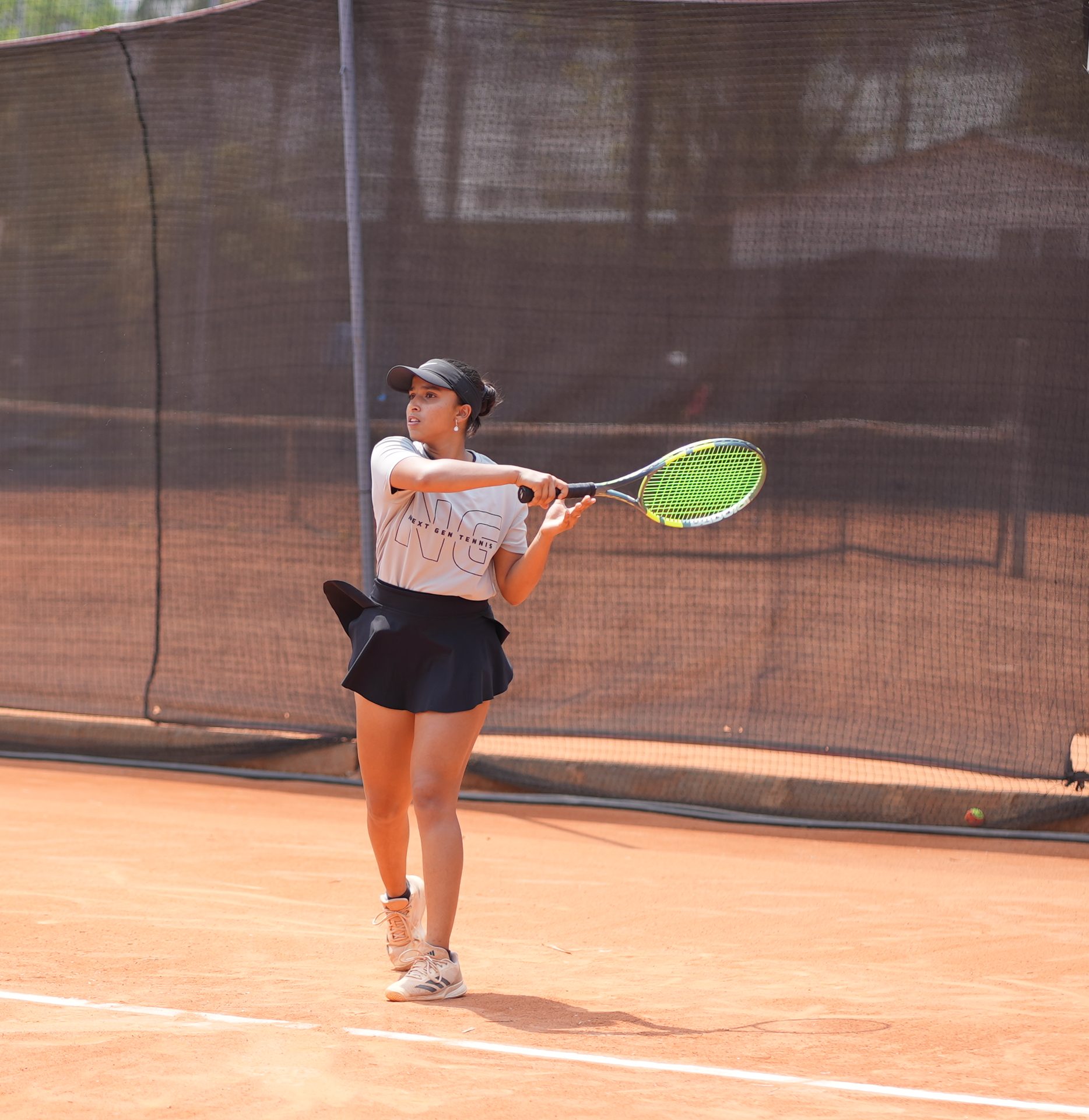 Player at the academy mid-forehand
